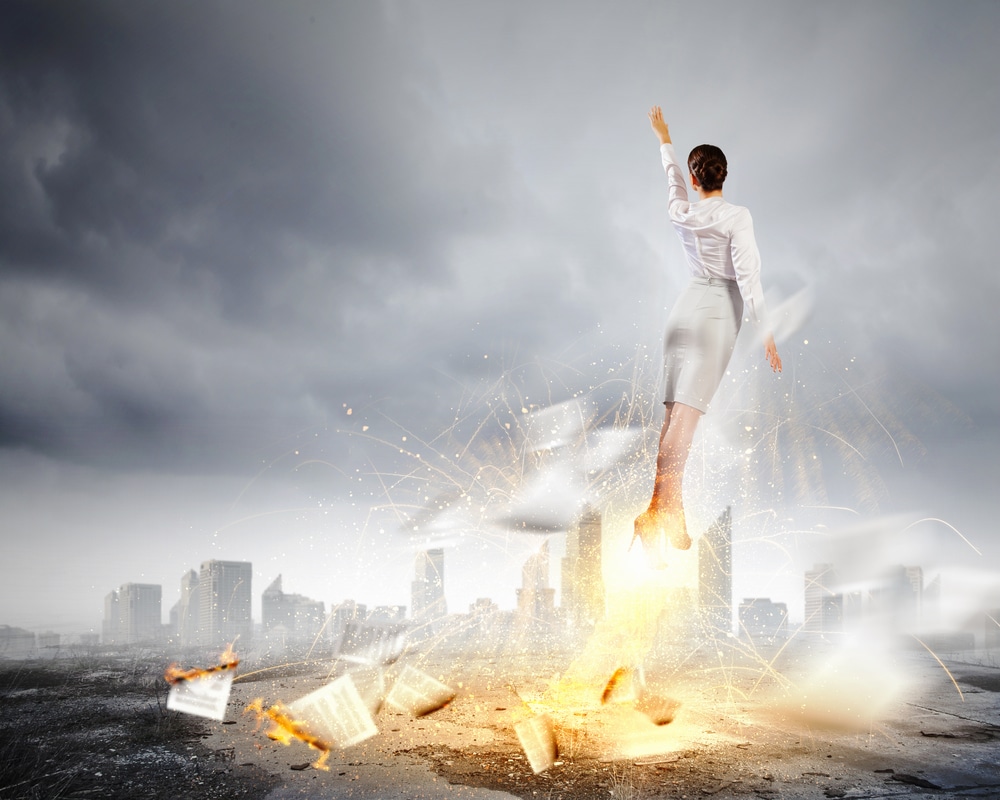 Image-of-businesswoman-flying-up-into-sky